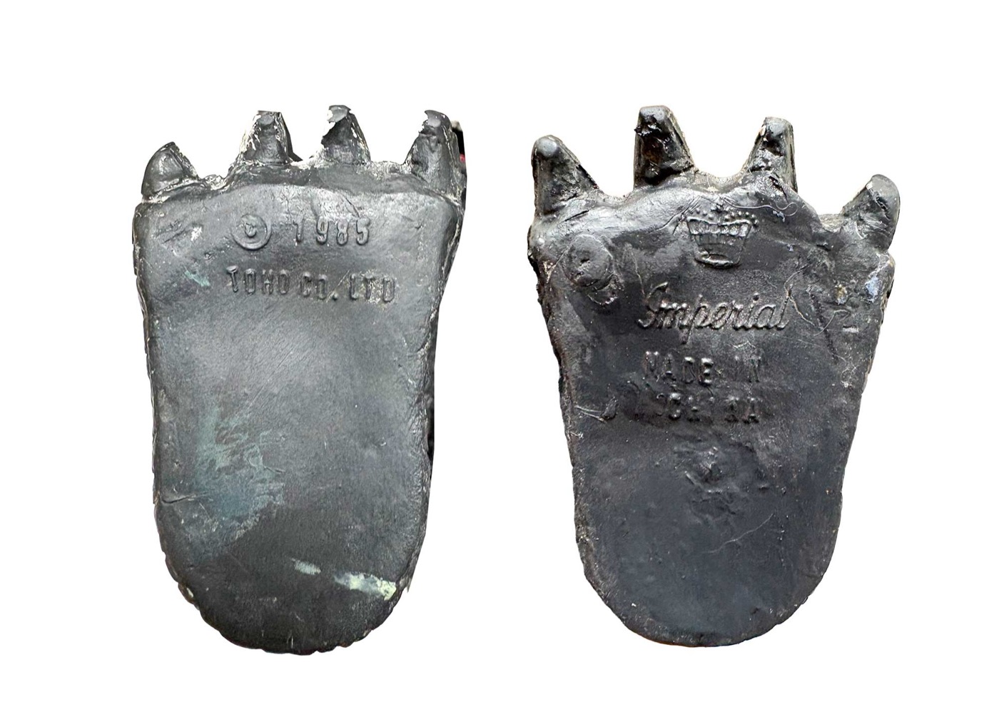 The undersides of an Imperial Godzilla's feet, moulded with the Toho 1985 copyright on one and the Imperial name on the other