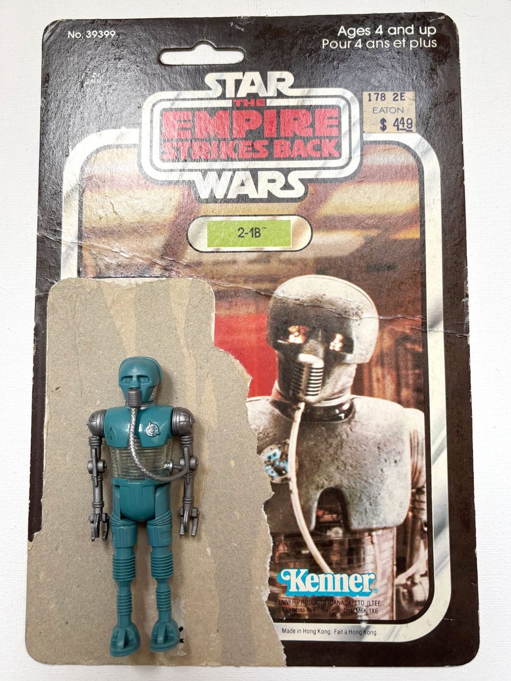 A Kenner Empire Strikes Back 2-1B figure in front of its original cardback, numbered 39399, with the Kenner logo and the words Ages 4 and up above Pour 4 ans et plus