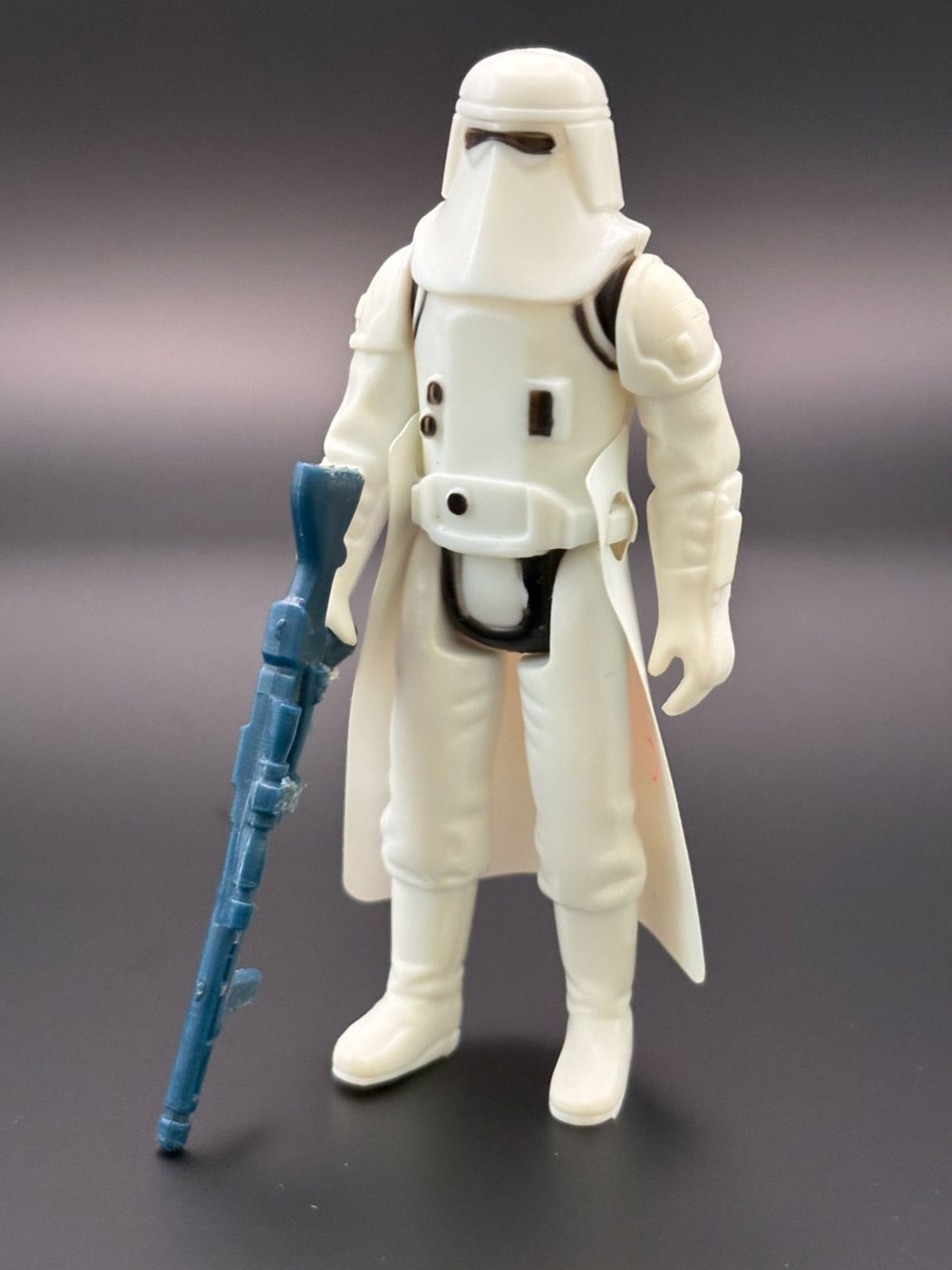 A Kenner Hoth Stormtrooper Snowtrooper figure standing with its original blue-grey blaster rifle and its moulded cape
